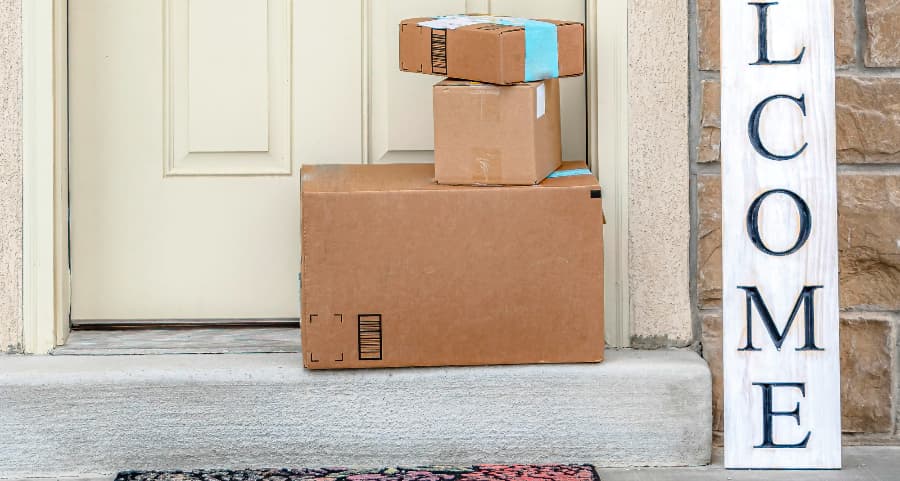 Boxes by the door of a residence with a welcome sign in Cincinnati